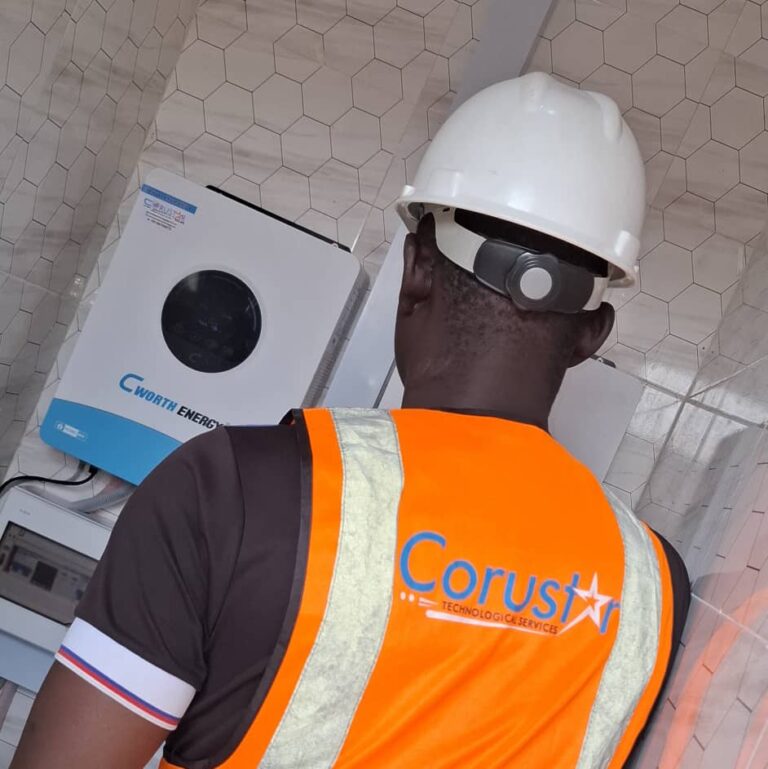 Corustar technician in a branded safety vest configuring a hybrid inverter