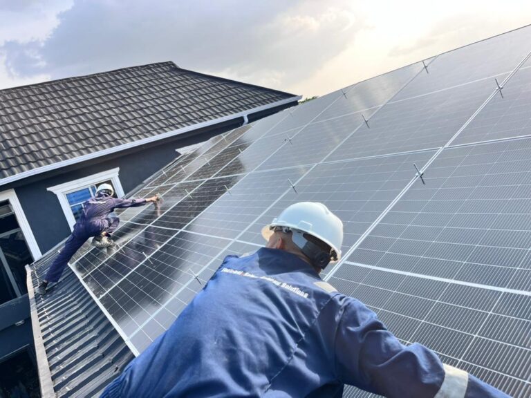Technician installing solar panels on a residential roof